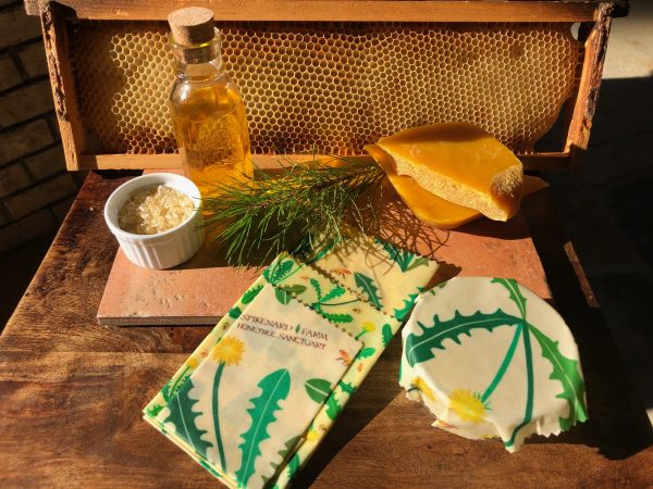 Display of beeswax wraps with ingredients: jojoba oil, beeswax and pine resin