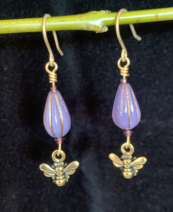 Earrings: Austrian crystal and Czech glass with cast bronze bee. Shades of lavender and gold, gold finish ear wires