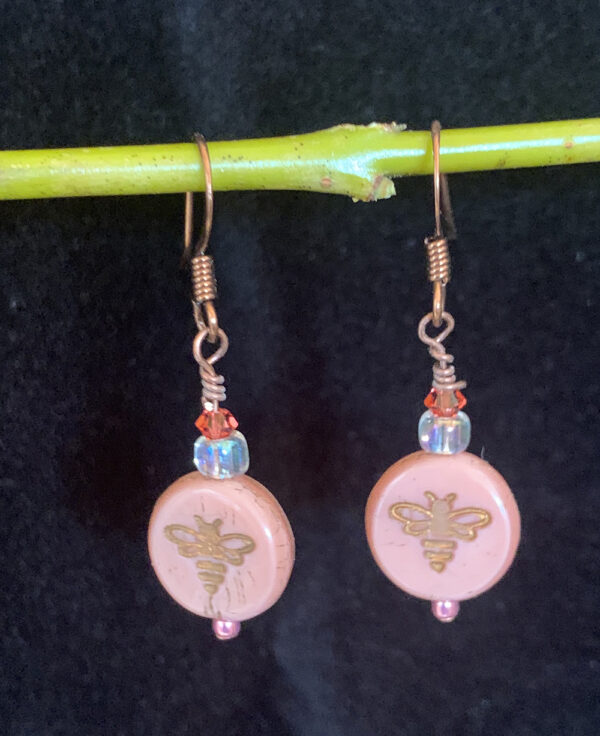 Earrings: Austrian crystals and Czech glass stamped with gold bee bee. Shades of peach, orange, iridescent clear, copper finish ear wires