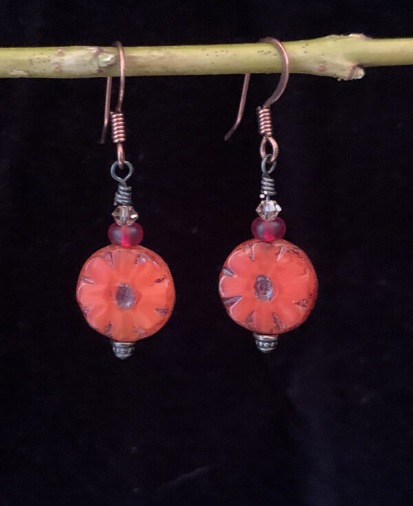 Earrings: Austrian crystals, Czech glass flower. Shades of orange, red and clear, copper finish ear wires